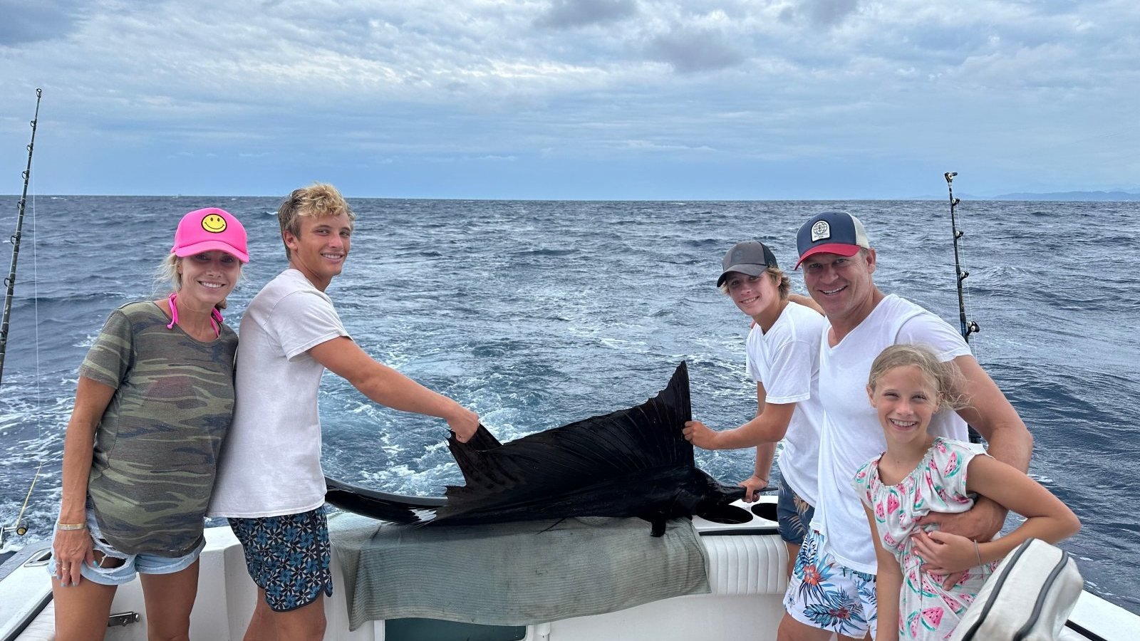 A family with their sailfish on the deck of Guanatuna during a private family fishing trip in Puerto Vallarta