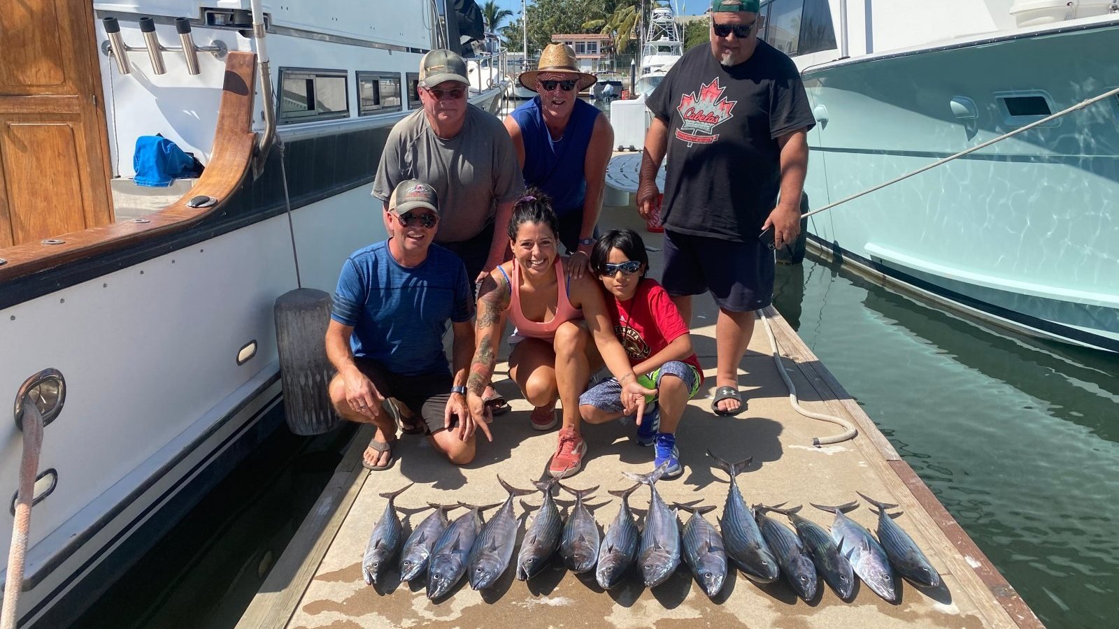 A charter group with their tuna catch on the dock at Marina Nuevo Vallarta after a private fishing trip with Ol' Salty's Ranch