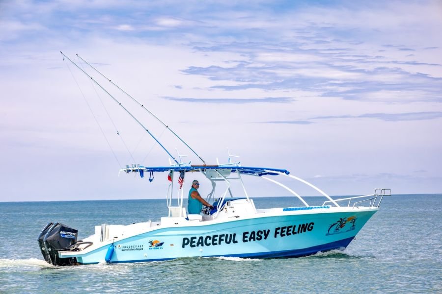 Peaceful Easy Feeling running with her shade canopy up and outriggers rigged for trolling