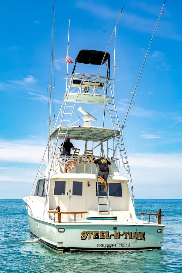 Steel n Time at anchor with her tuna tower against a clear sky