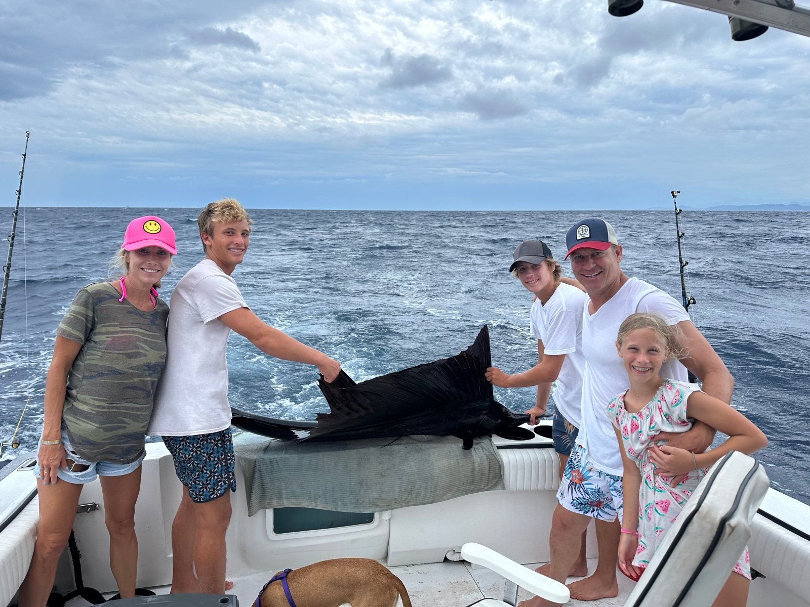 A family with a sailfish on the deck of a private fishing charter in Banderas Bay, Puerto Vallarta