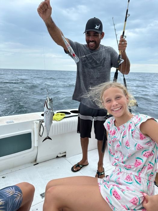 Father and daughter with a first catch of the day