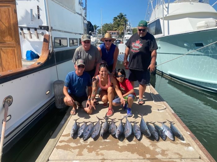 A full charter group with their catch back at the marina